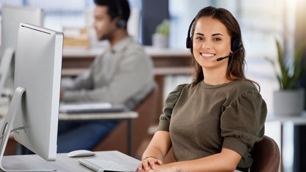 Atendente feliz durante sequência de atendimentos no contact center da empresa